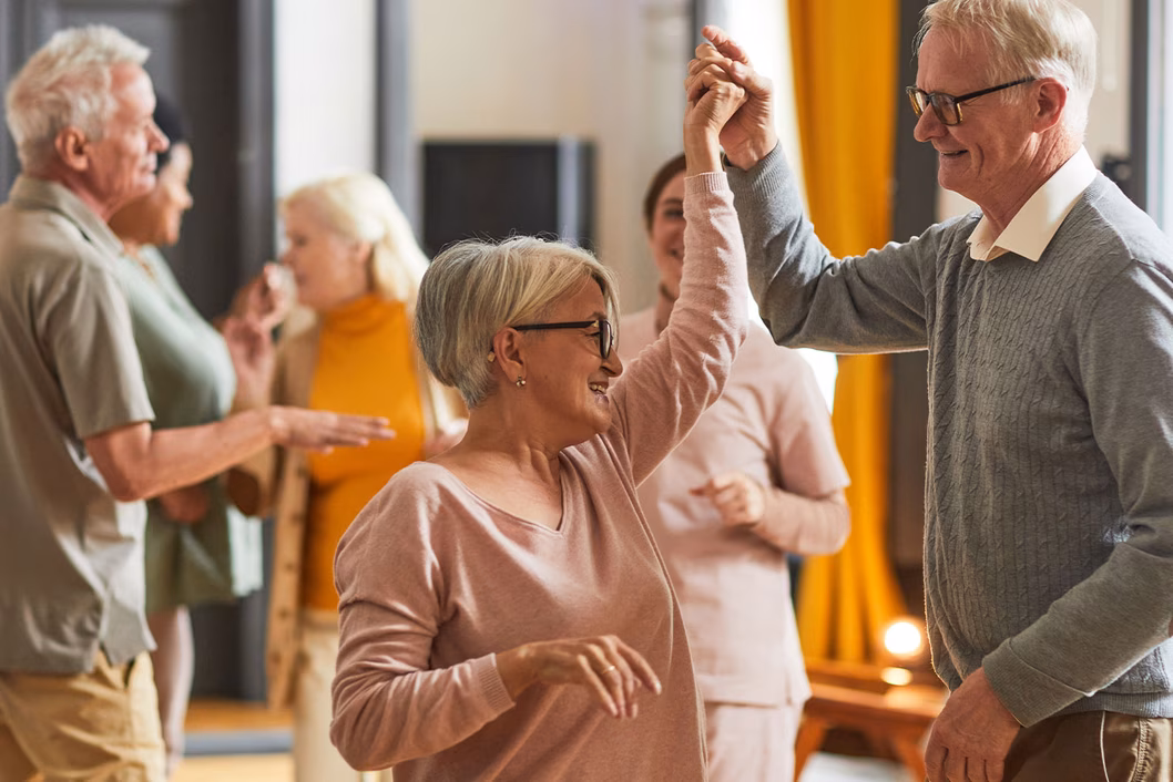 Photo of people dancing while wearing earthy tones