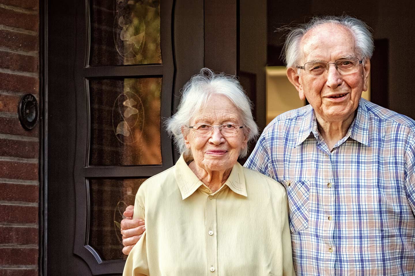 Photo of an older couple smiling at the camera