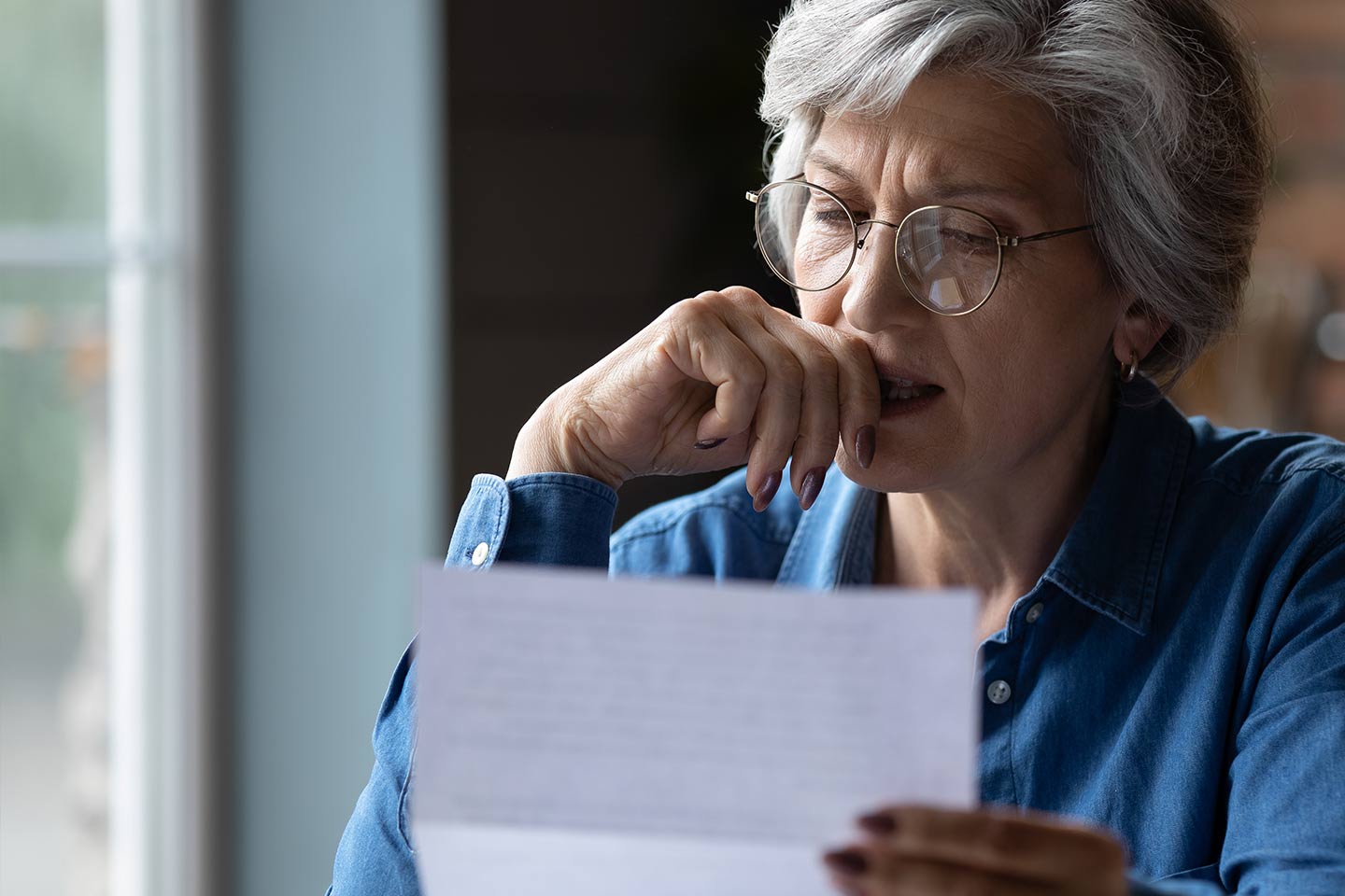 Photo of a woman reading a letter
