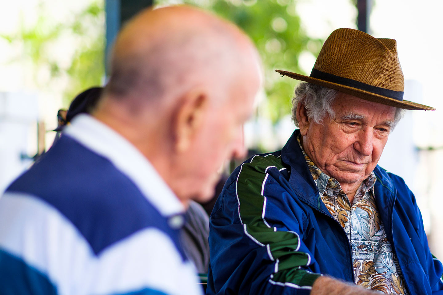 Photo of a man in a straw hat and blue jacket
