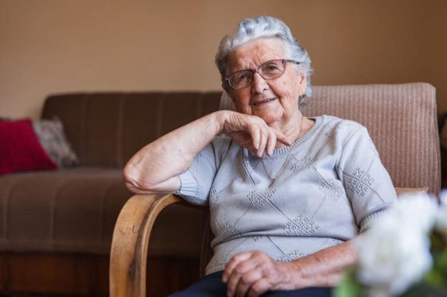 Photo of a smiling woman sitting in an arm chair