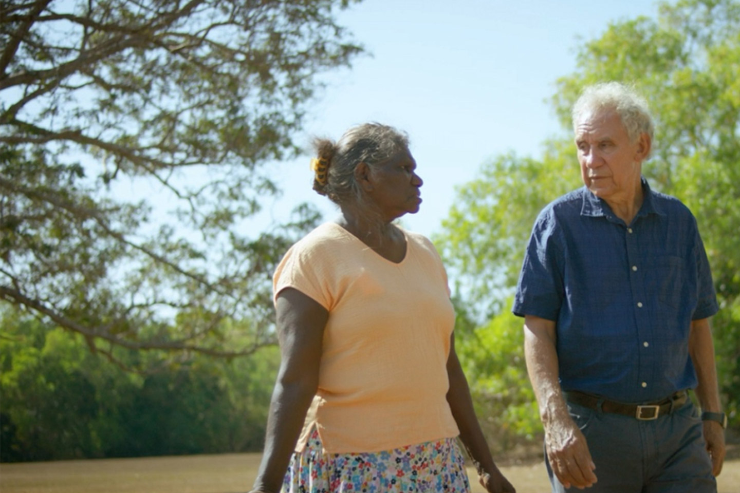 Photo of a woman and man walking outdoors