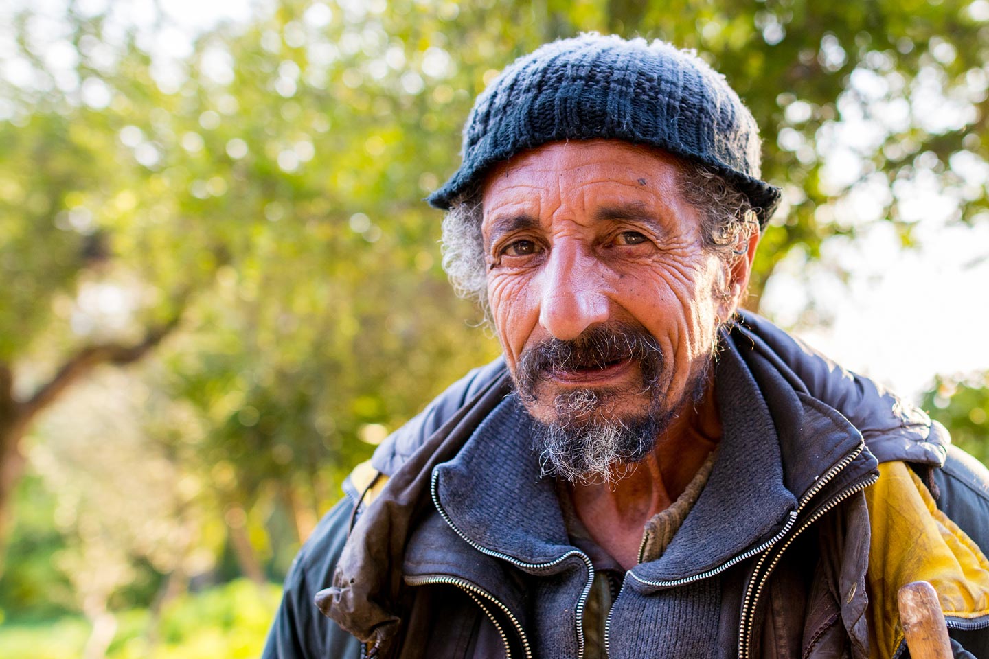 Photo of a man wearing layers of jackets and a knit cap