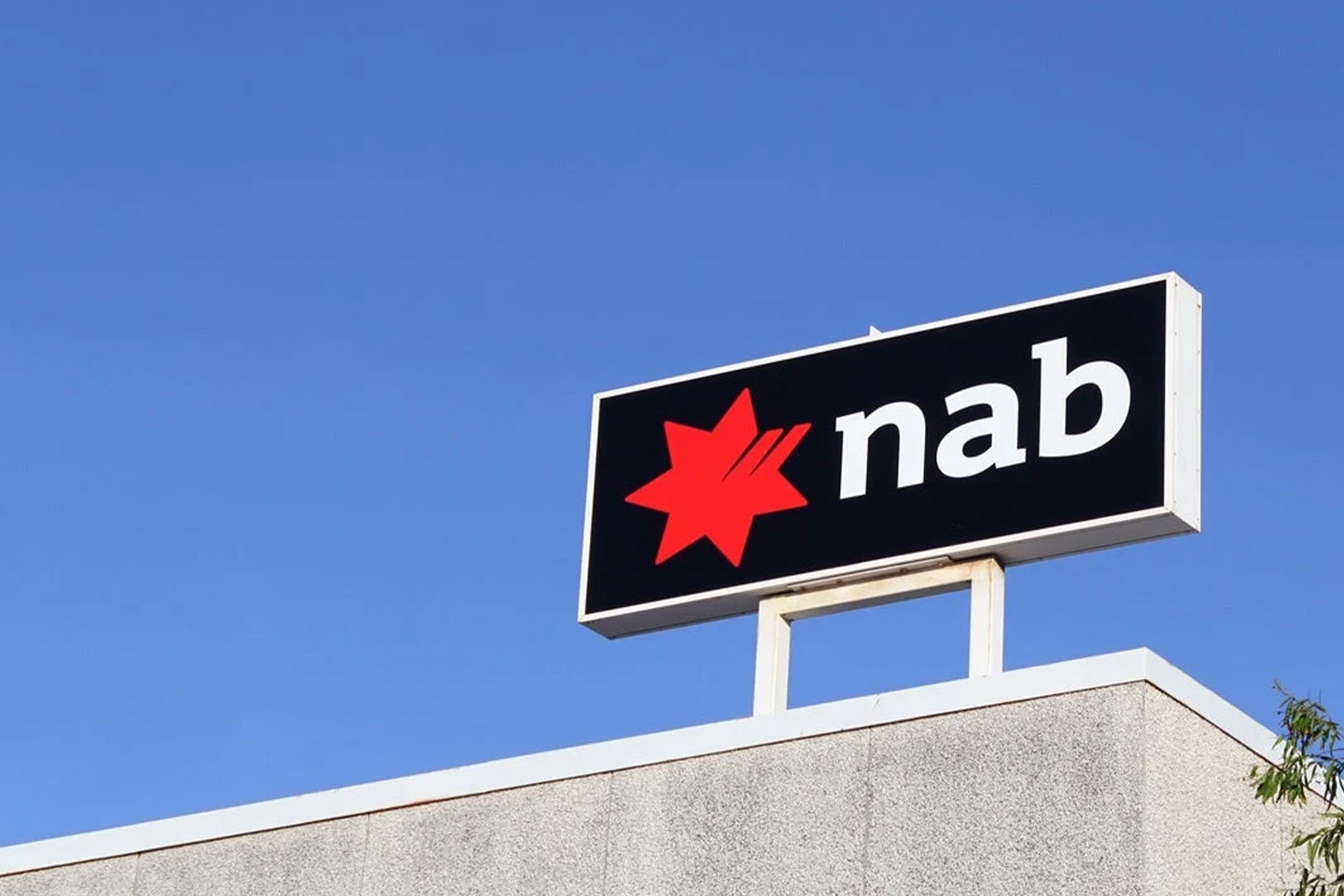 Photo of NAB sign on top of building