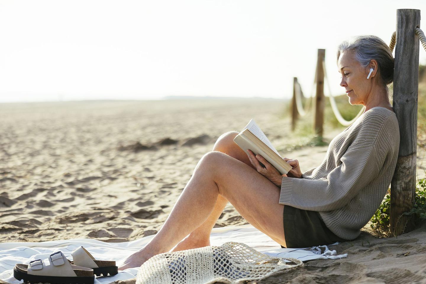 Photo of woman reading on a beach