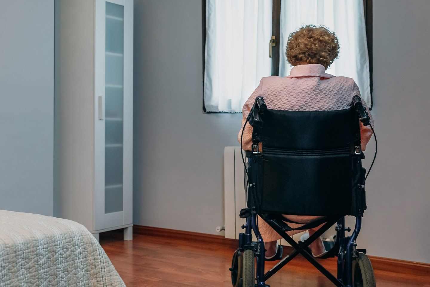 Photo of a woman in a wheelchair with her back to us