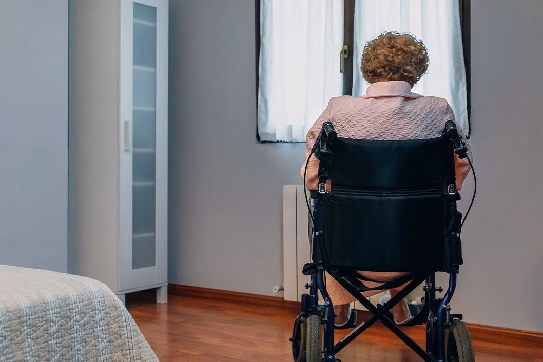 Photo of a woman in a wheelchair with her back to us