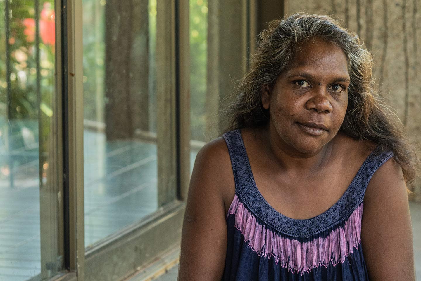 Photo of woman wearing a blue and mauve top