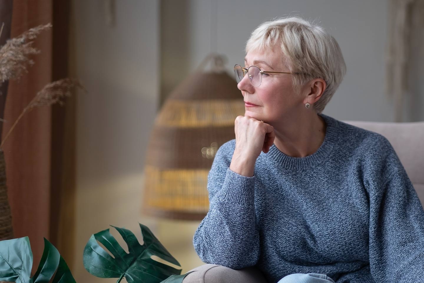 Photo of woman with a pixie cut and her chin on her fist