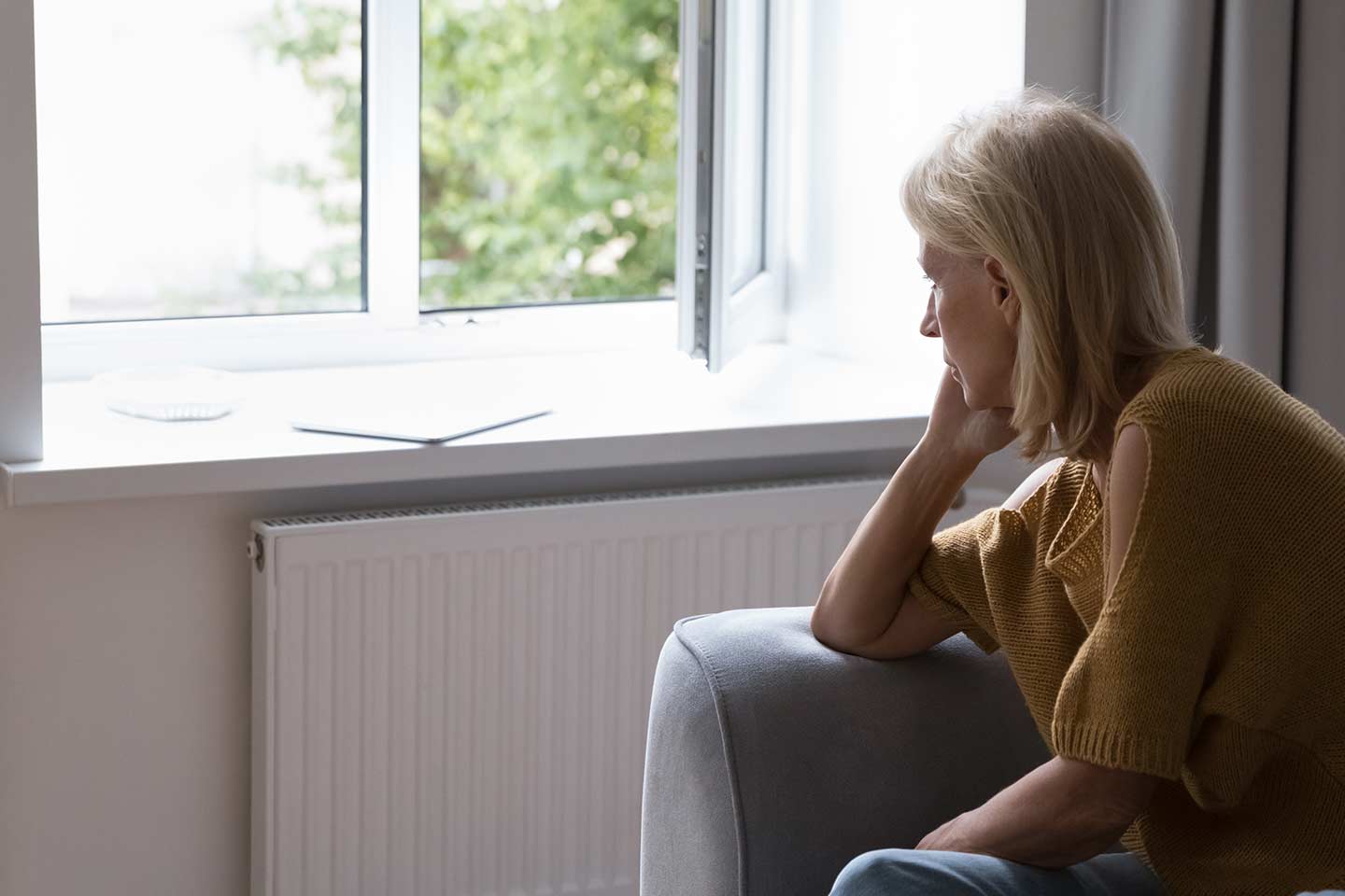 Photo of woman staring out window