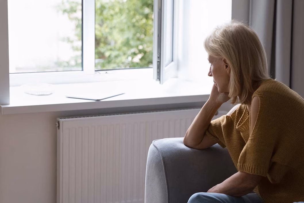 Photo of woman staring out window