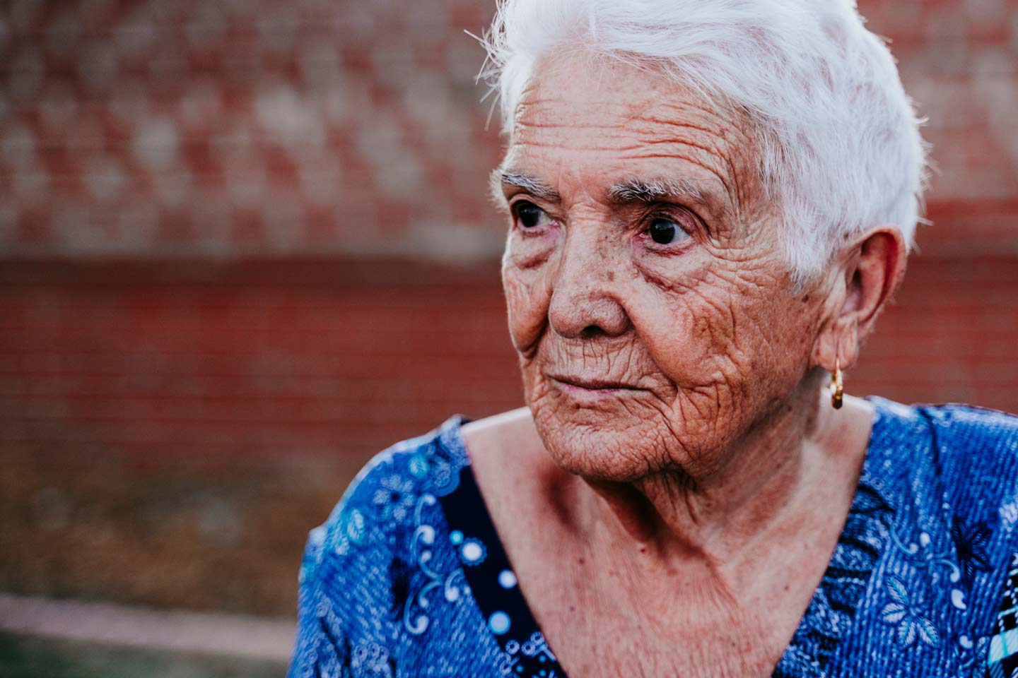 Photo of a woman with short white hair in a blue dress
