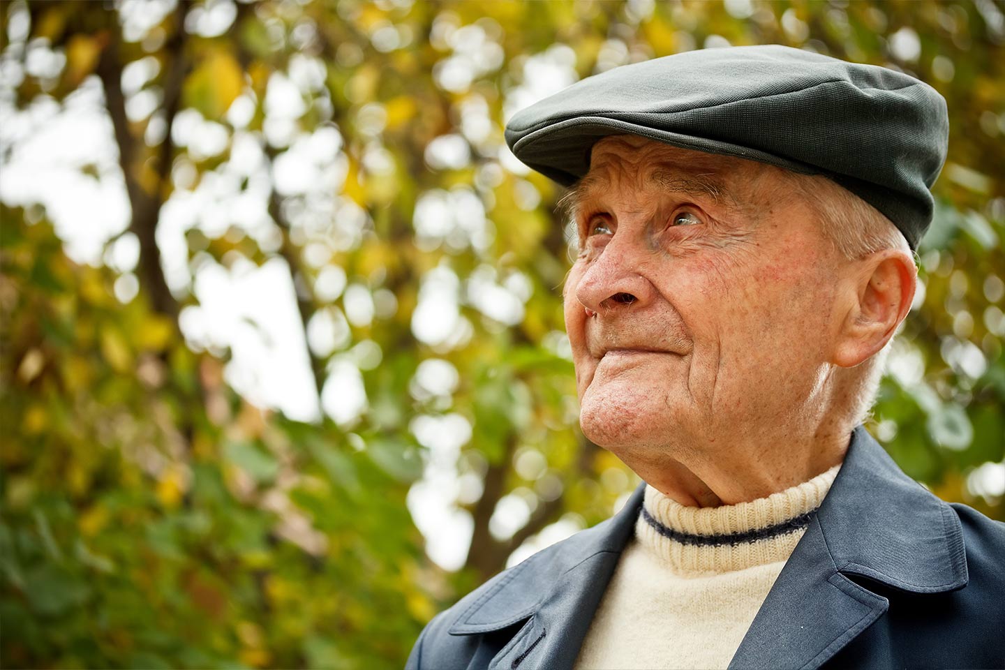 Photo of a man wearing a cap outdoors