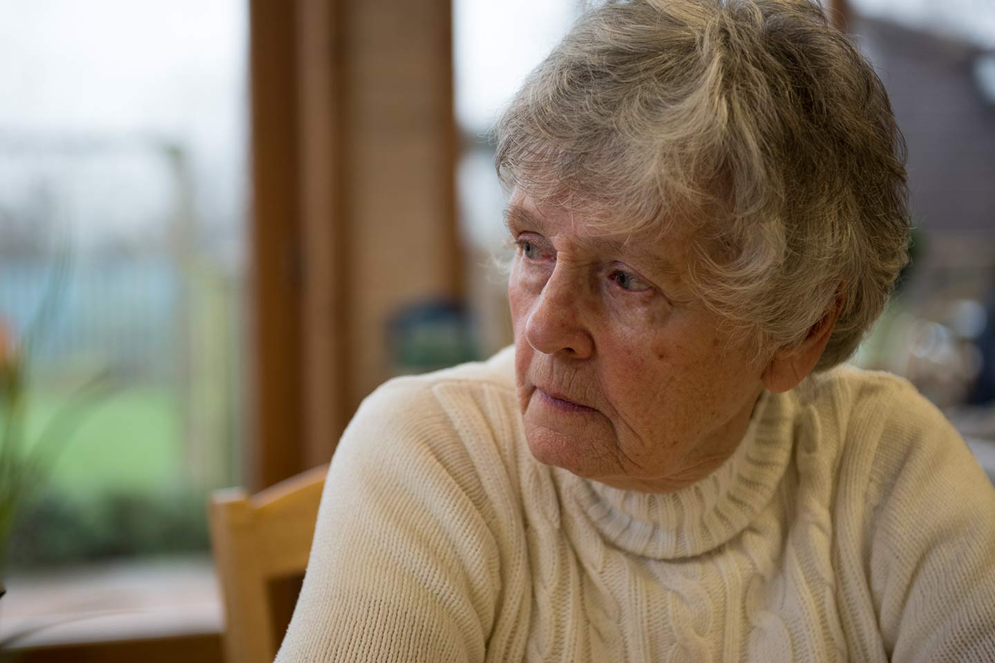 Photo of woman in a cream cable knit jumper