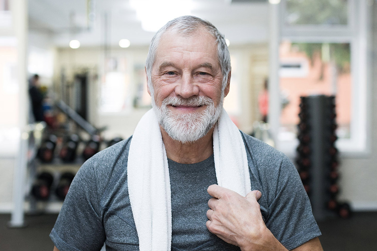 Happy older man at the gym