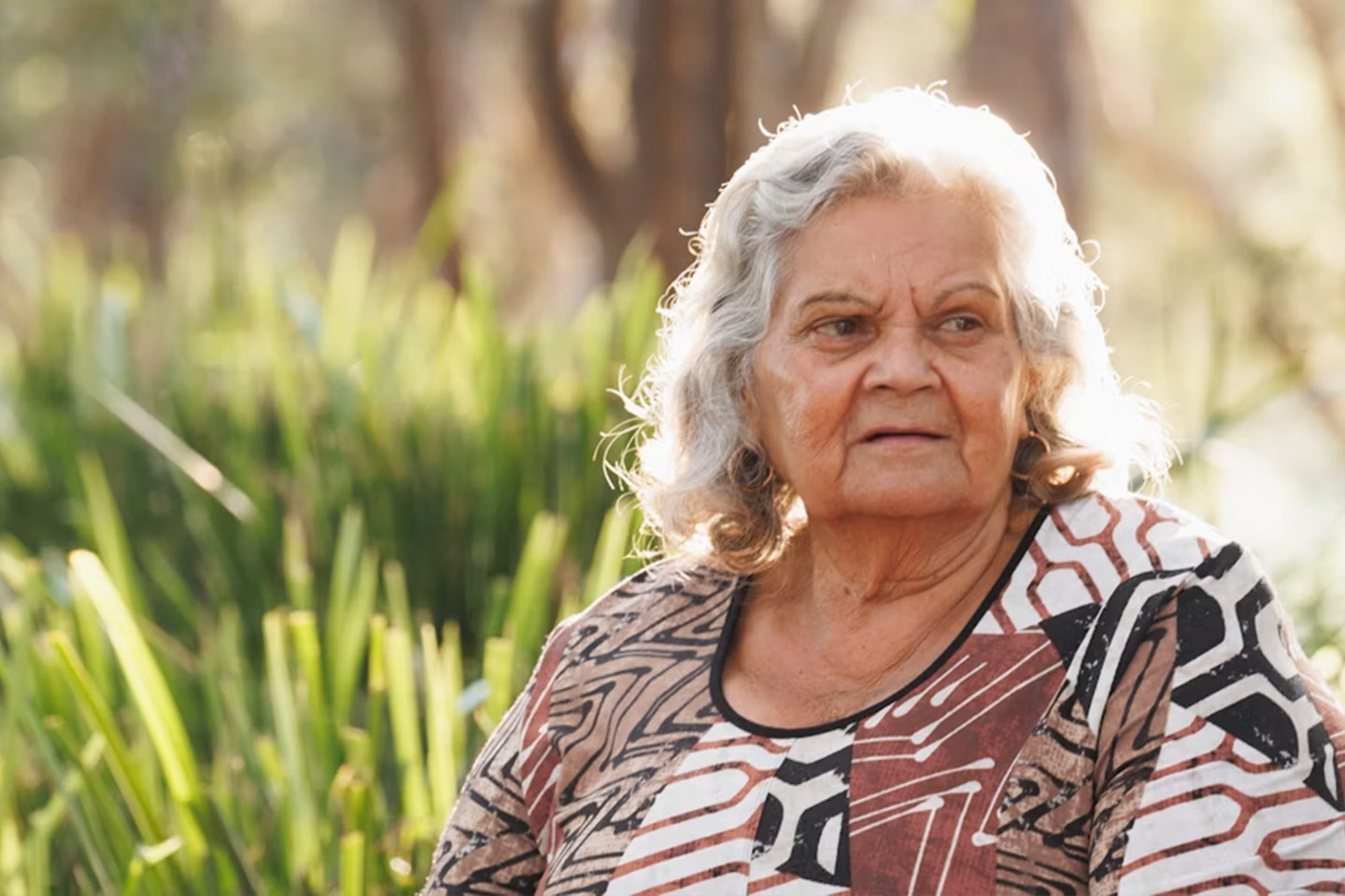 Photo of a woman in an earthy print top outdoors