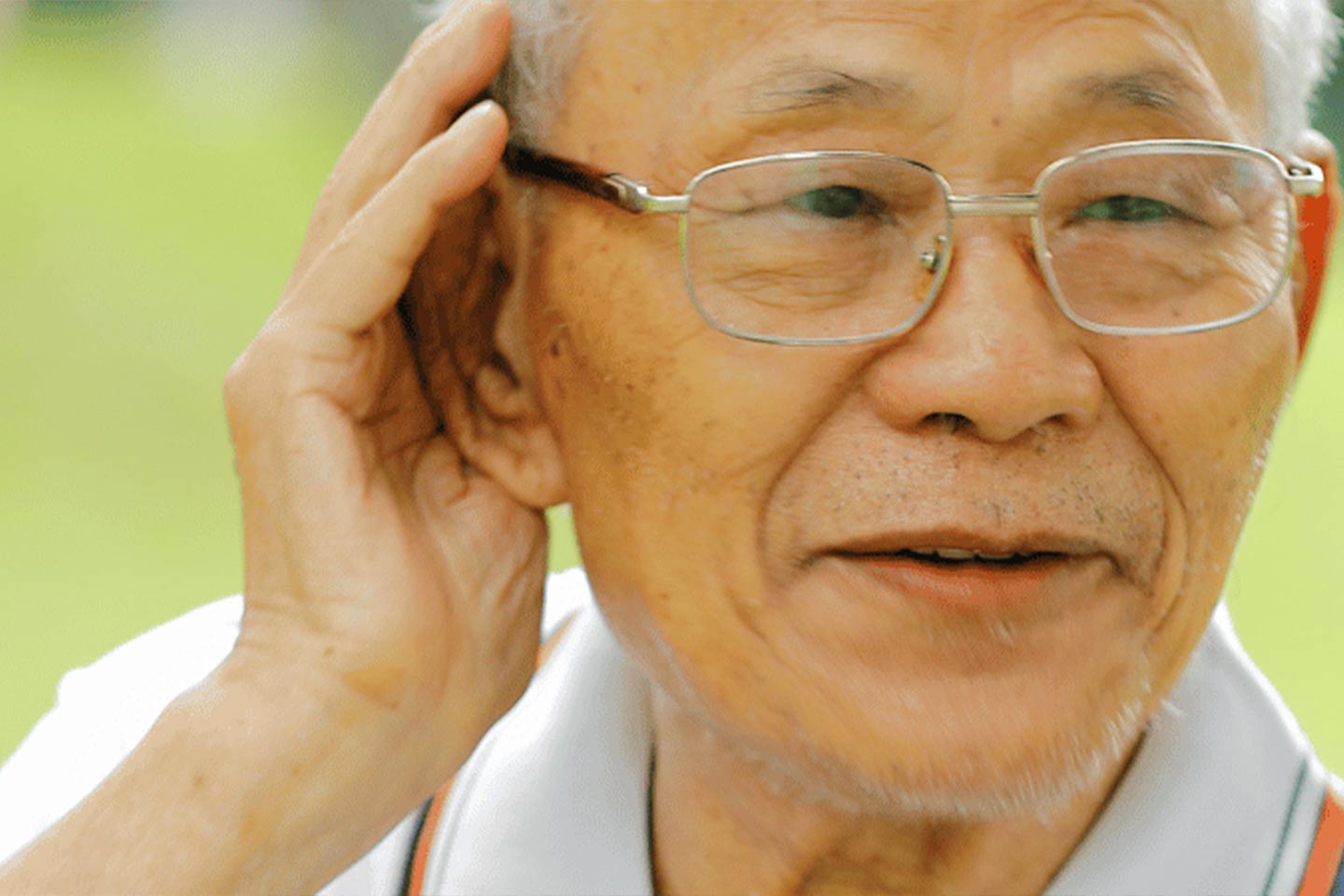 Photo of man cupping hand to ear