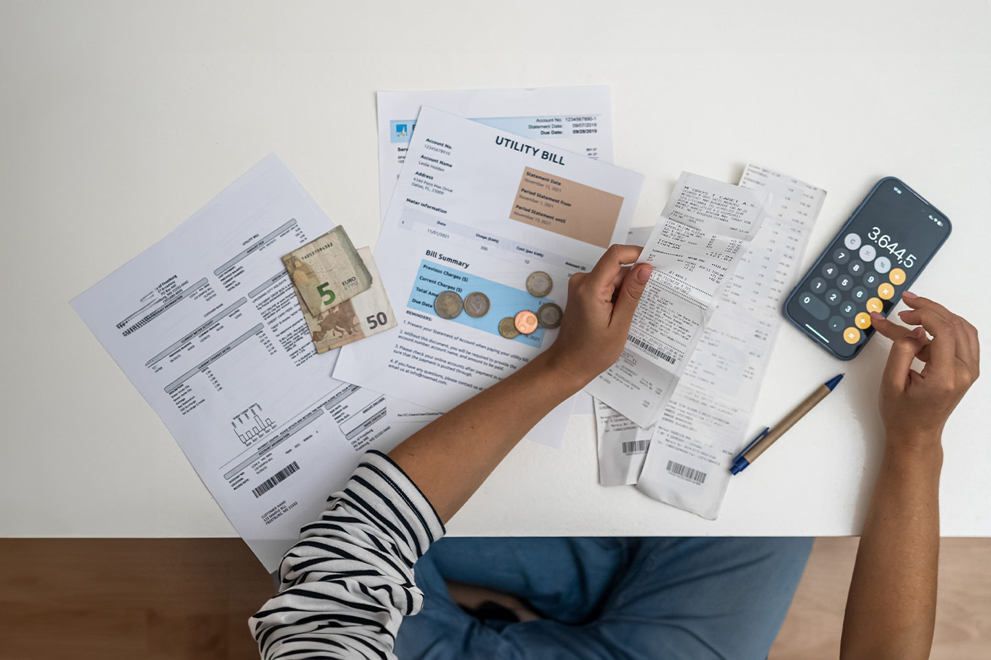 Photo of someone budgeting with bills and calculator