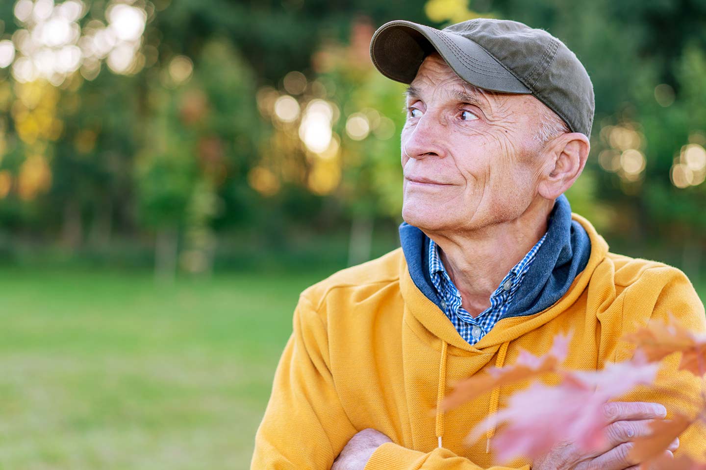 Photo of a man in a green cap and yellow hoodie