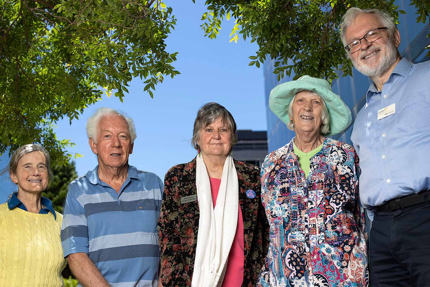 Photo of a group of people outdoors smiling for the camera