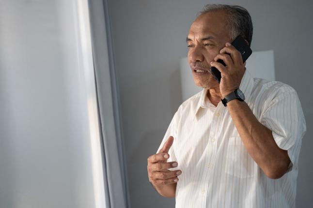 Photo of a man using a mobile phone