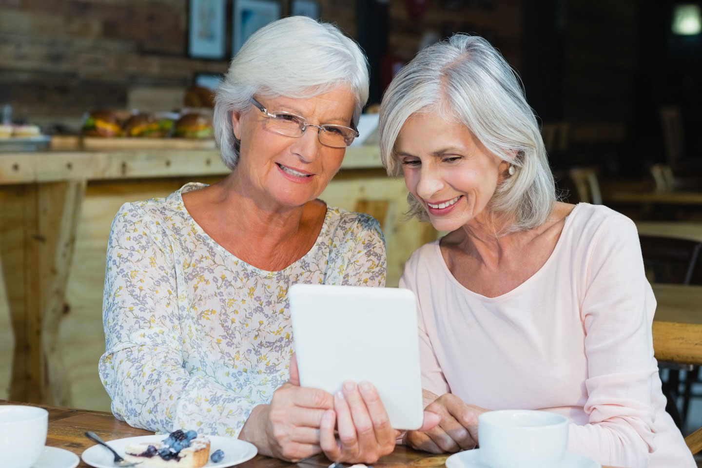Senior couple reading from tablet