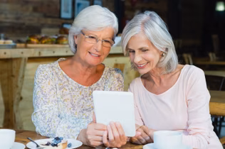 Senior couple reading from tablet