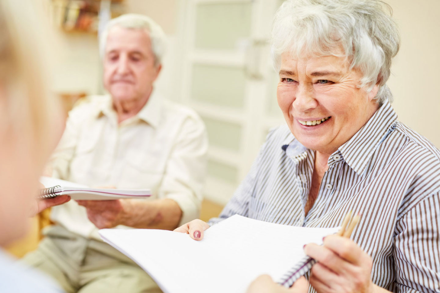Photo of smiling woman with paperwork