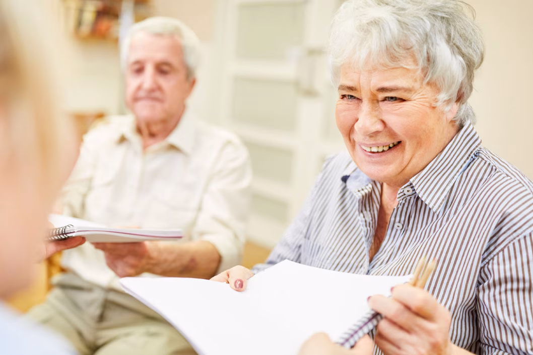 Photo of smiling woman with paperwork