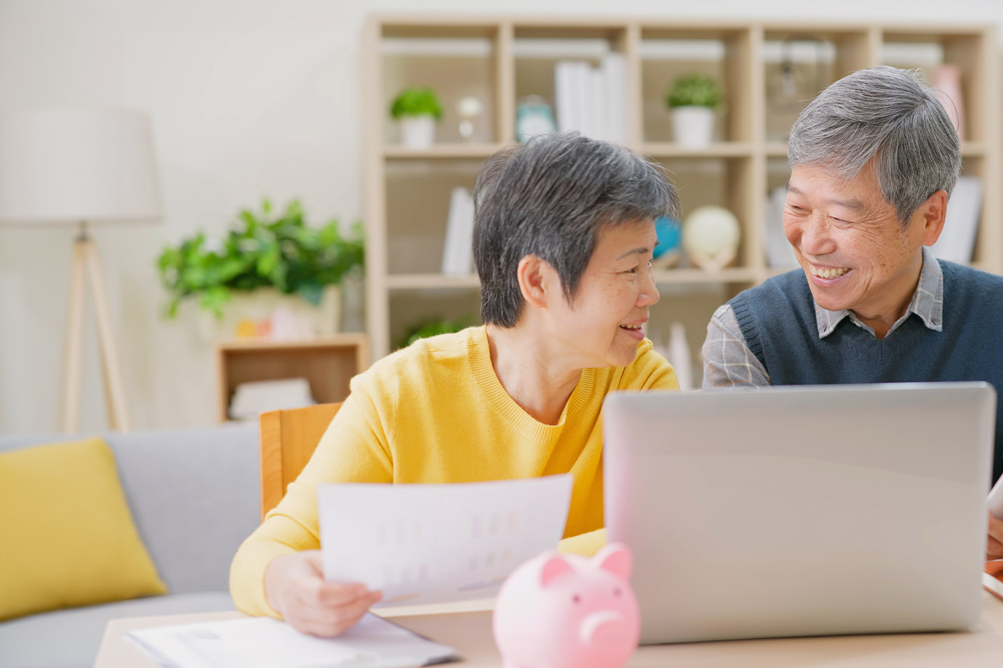 Photo of couple smiling together with laptop