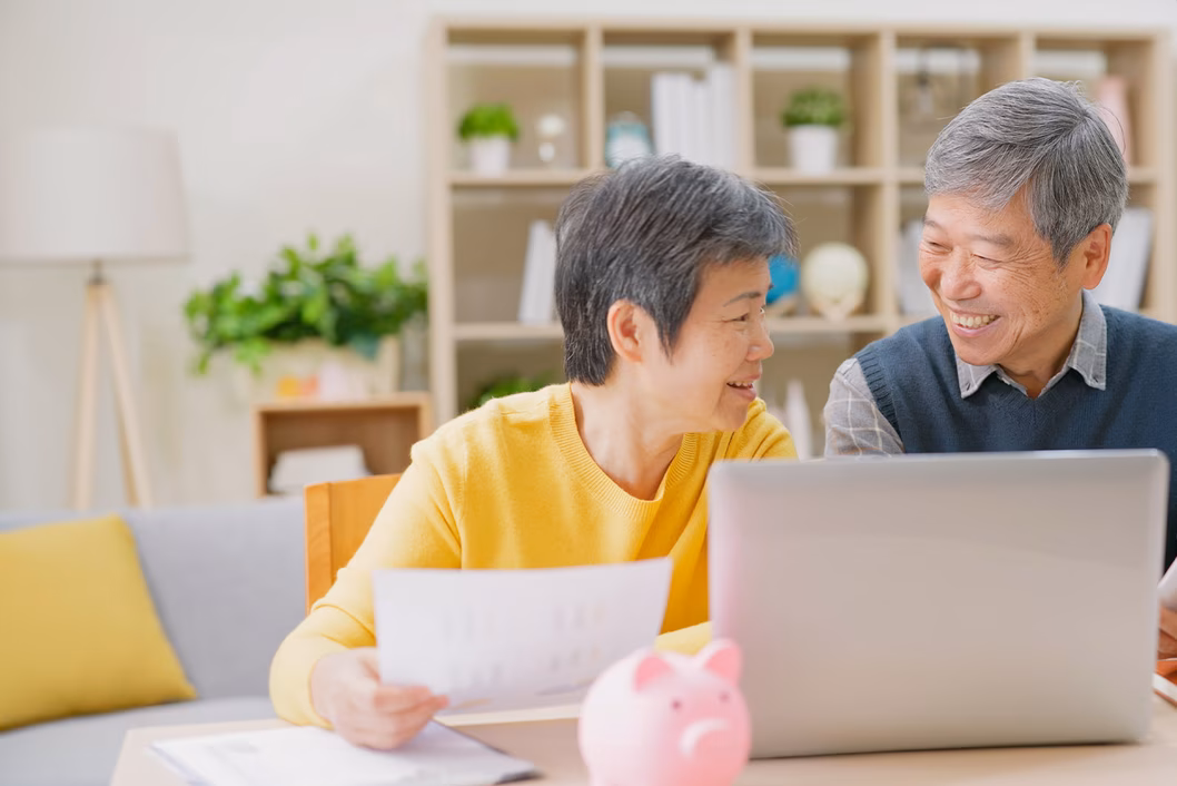 Photo of couple smiling together with laptop