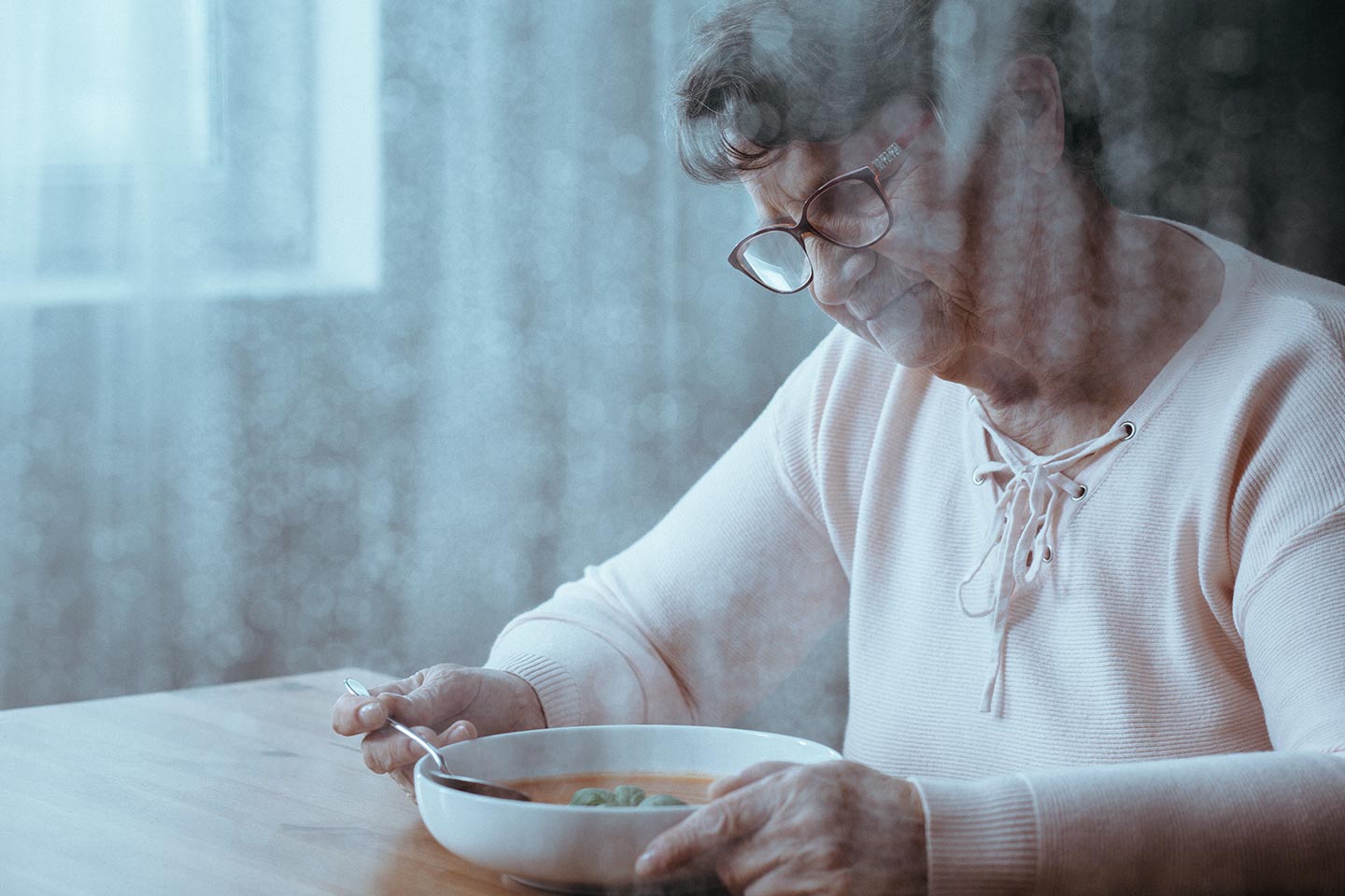 Photo of woman staring into her bowl of soup