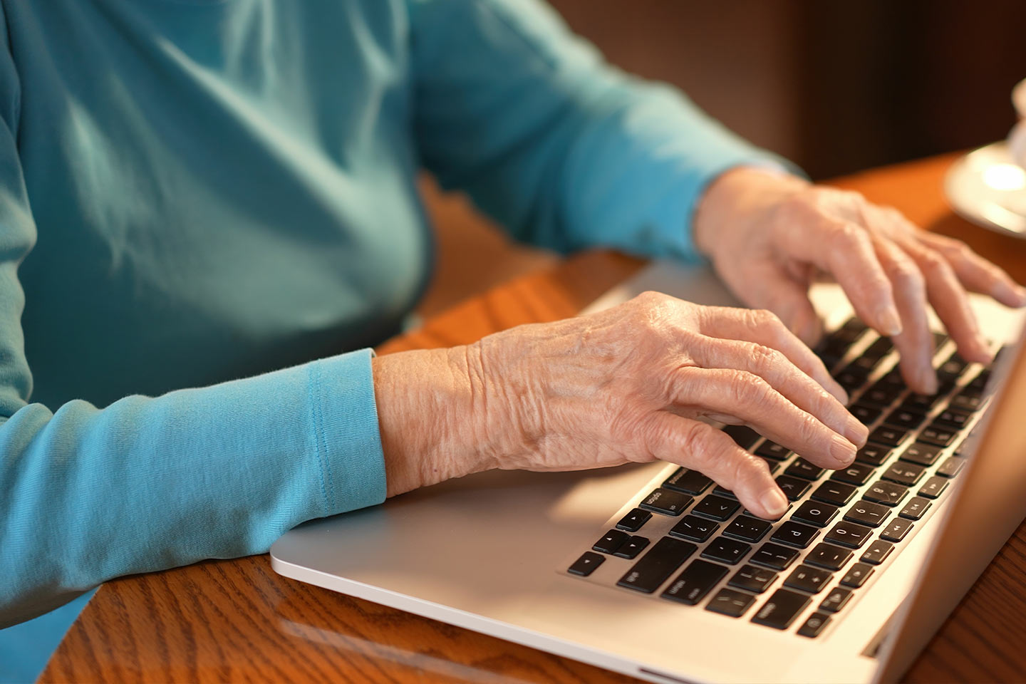 Photo of hands on a laptop keyboard