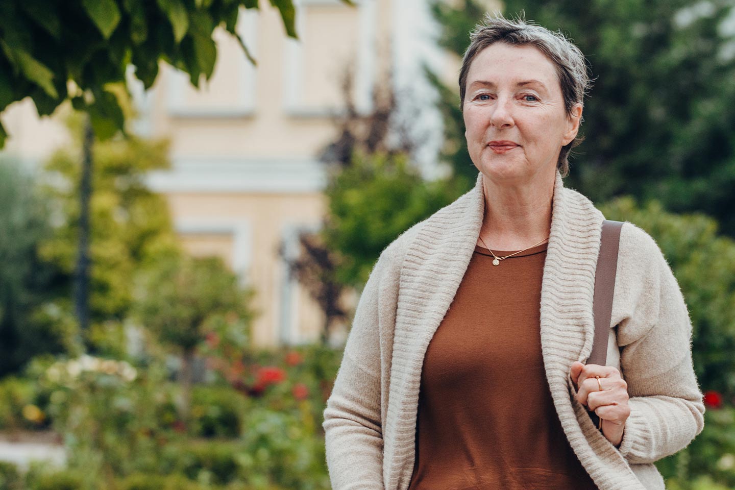 Woman wearing a taupe cardigan in a park