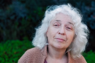 Image of an older woman with shoulder length white hair