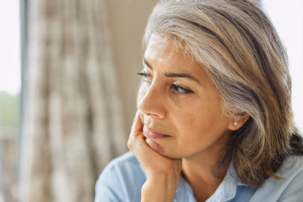 Photo of a woman with her chin in her hand