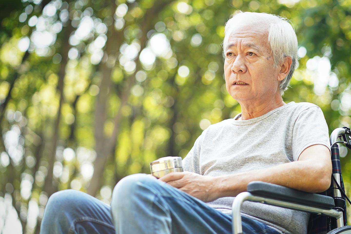 Photo of a sad looking man sitting in a wheelchair