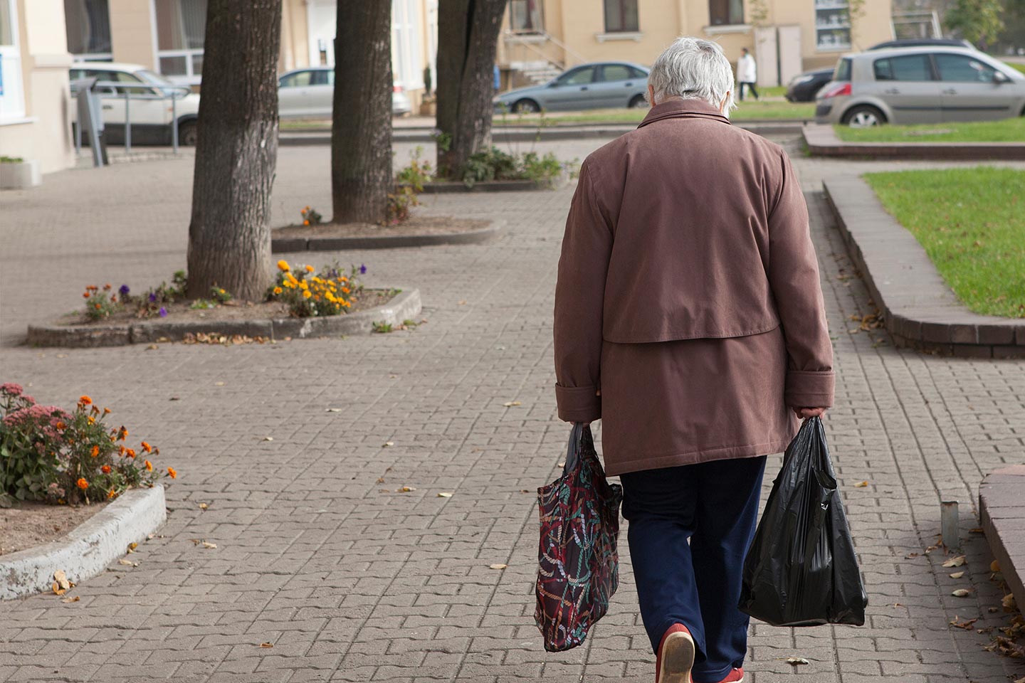 Photo of a woman in a brown coat with shopping bags