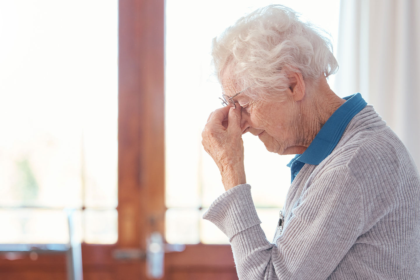 Photo of a woman pinching the bridge of her nose