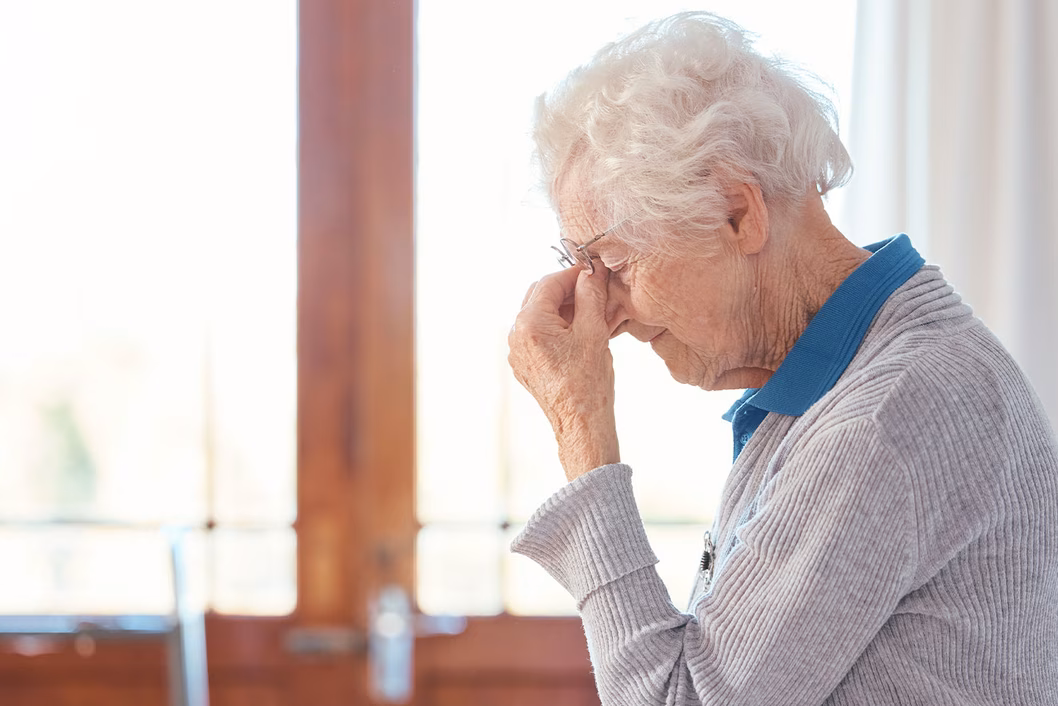 Photo of a woman pinching the bridge of her nose