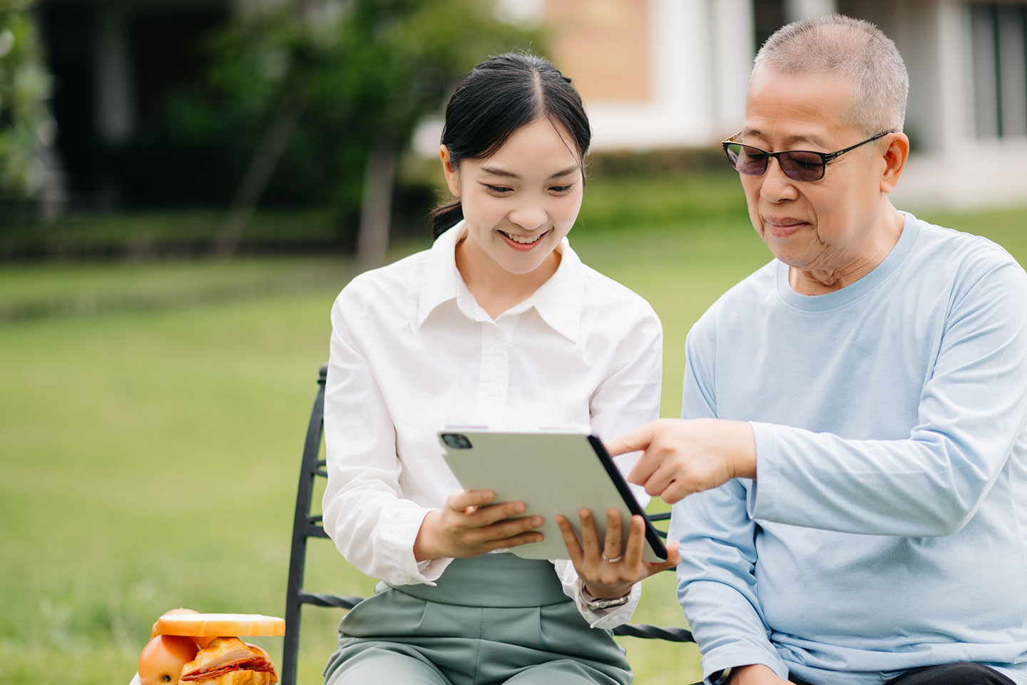 Photo of young woman and senior man seated together