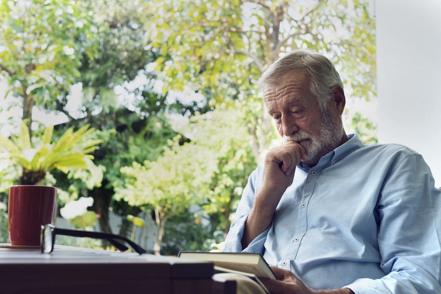senior man reading on deck 