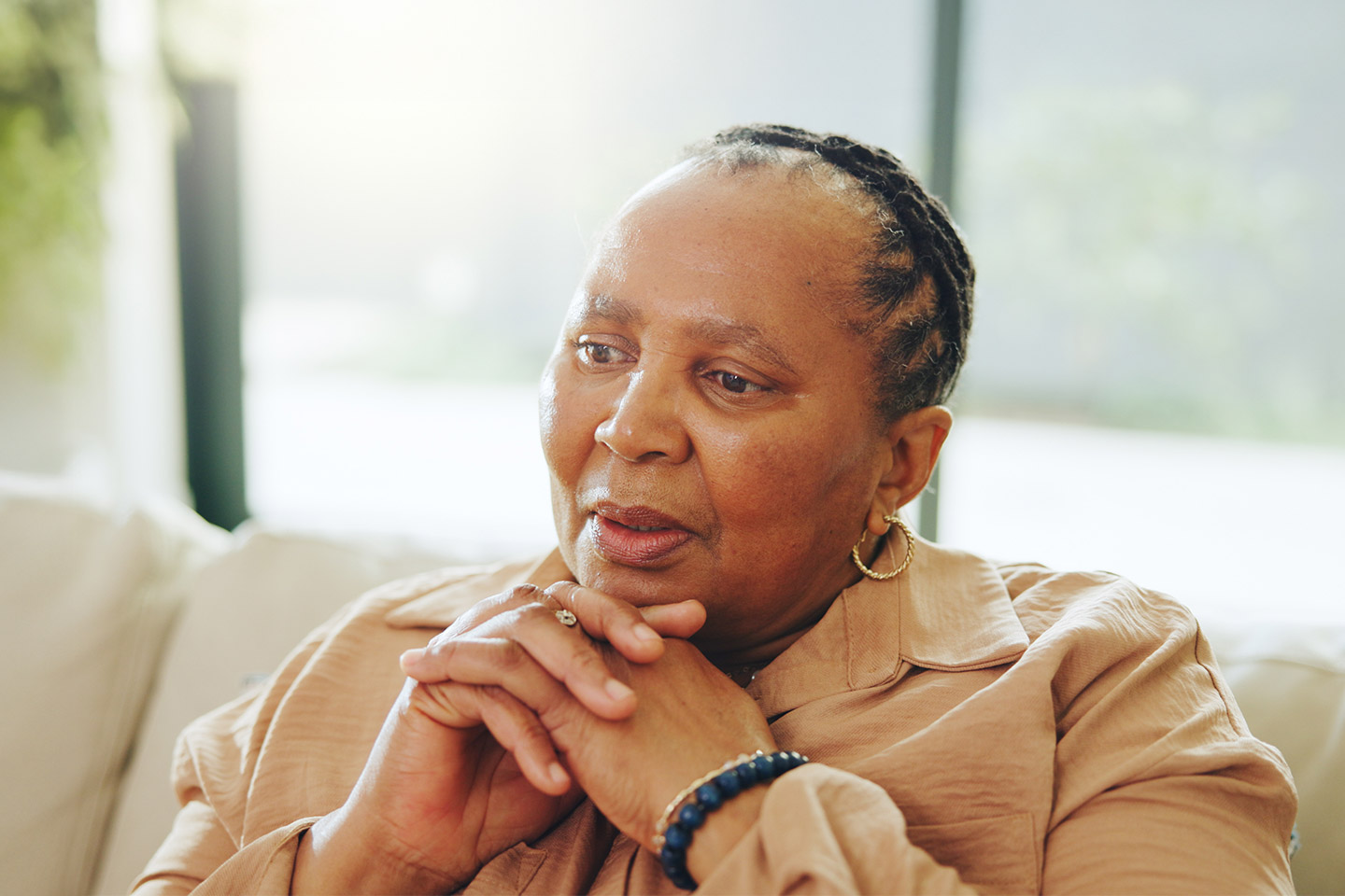 Image of an older woman sitting on a sofa