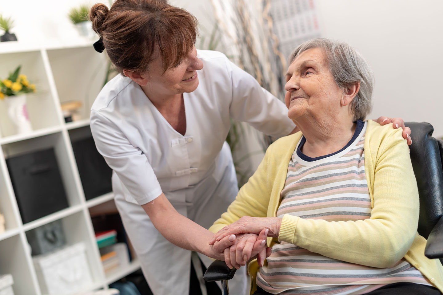 Photo of woman in wheelchair enjoying a nurse visit