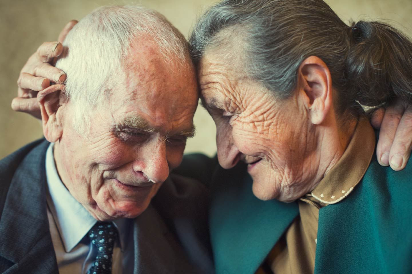 Photo of an older couple lovingly embracing