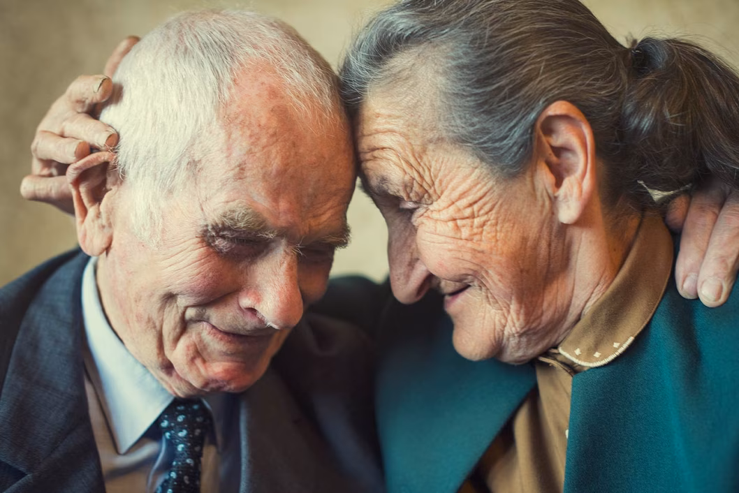 Photo of an older couple lovingly embracing