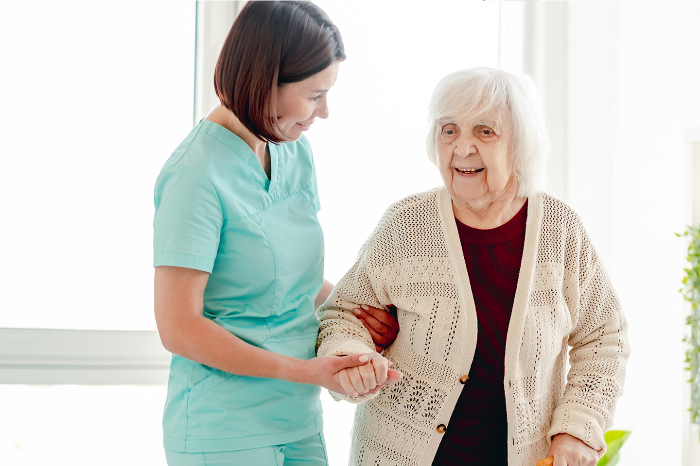 Photo of a health practitioner helping an older woman