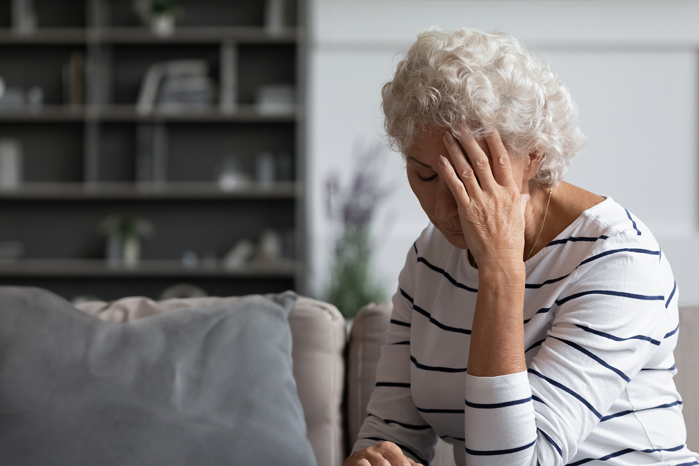 Photo of a woman with her head in her hand