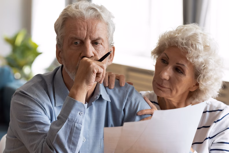 Picture of a wife and husband reviewing documents.