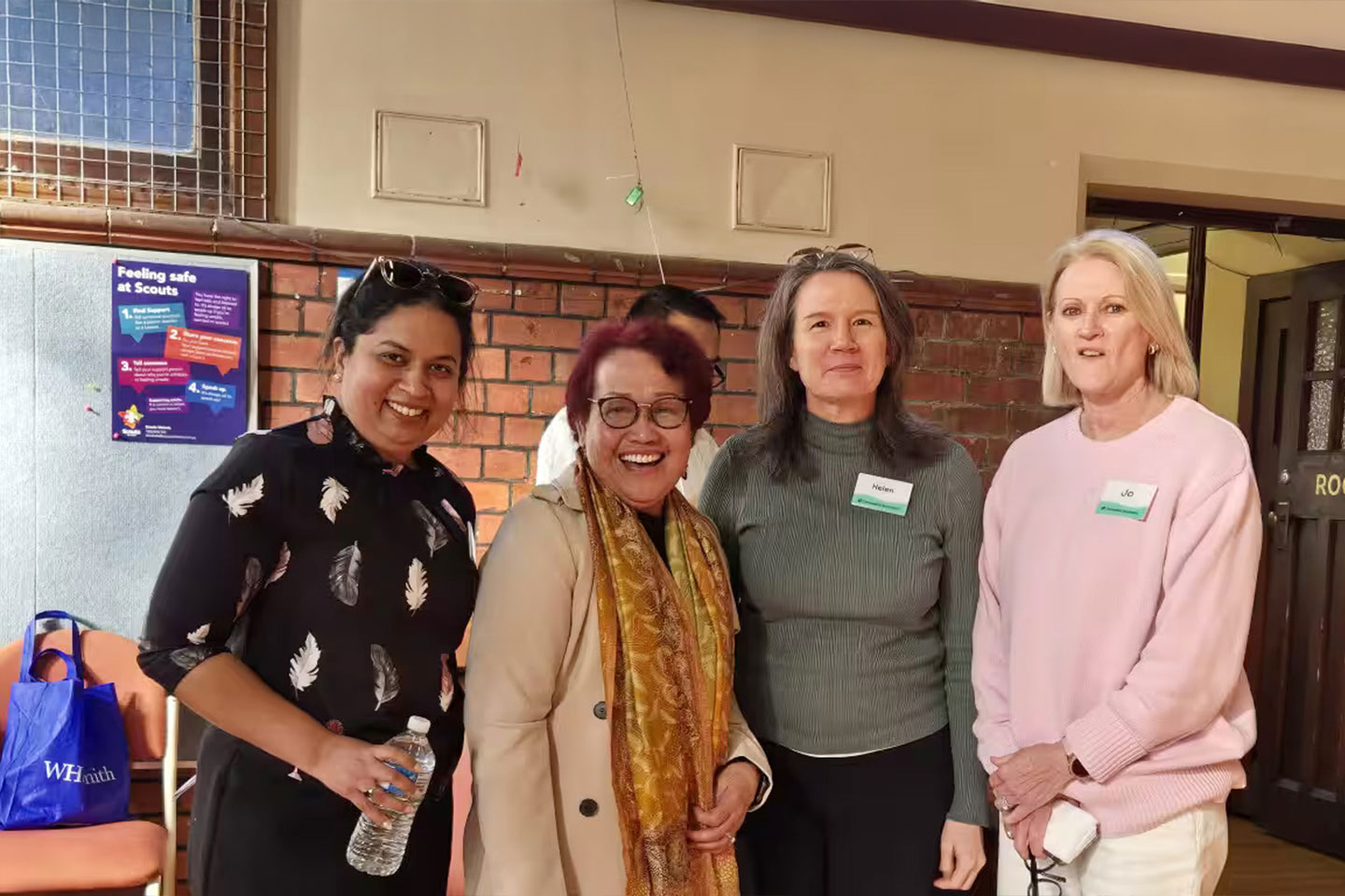 Photo of a group of people smiling at camera